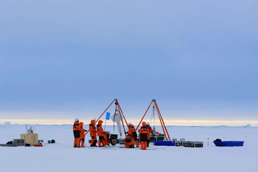 Members of China's 16th Arctic Ocean scientific expedition team work on the ice surface of the Arctic Ocean on Aug. 9, 2026.